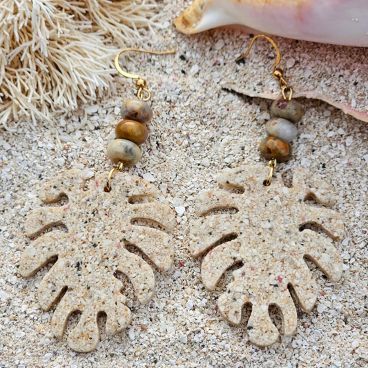 Leaf-shaped earring in beach sand